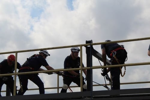 A technical rescue team working together on a mechanical advantage system