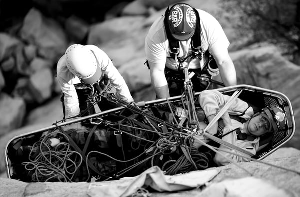 Rescuers Lower Patient In A Litter