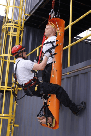 A rescuer acts as a litter attendant, or "barrelman", during an exercise at the Roco Training Center.